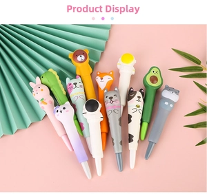 Flat lay of colorful cartoon squishy stress relief pens with cute animal characters