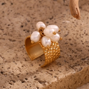 Macro detail of wide 18K gold plated ring with baroque pearls and hammered texture