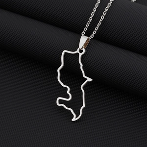 Macro detail of Martinique map pendant necklace in polished silver stainless steel