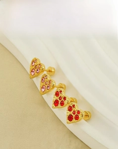 Macro view of heart-shaped earrings with pink and red stones in 18K gold finish