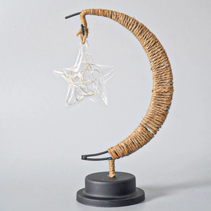 Close-up of crescent moon LED lamp with twine wrap and transparent glass star
