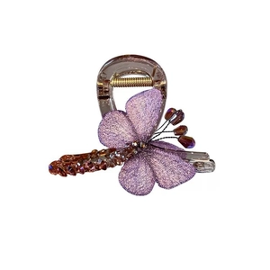 Elegant purple butterfly hair claw clip with amber gemstones on a white background