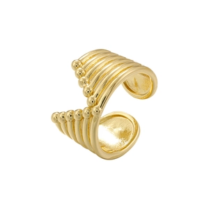 Close-up of golden metallic ear cuff featuring a beaded design and smooth fluid lines