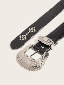 Close-up of black crocodile texture leather belt with silver hollow carved buckle