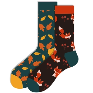 Detail of autumn crew socks featuring fox and maple leaf patterns in earthy tones