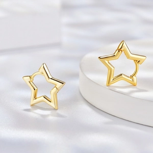 Minimalist gold star hoop earrings featuring a hollow cutout geometric design
