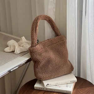 Brown fluffy faux fur handbag with a cozy plush texture for winter style