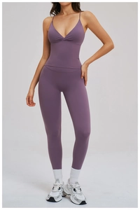 Detail of purple yoga set showing deep V-neck crop top and high waist seamless leggings