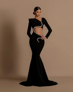 Detail of waist cutout with shimmering silver snake sequin trim on black mermaid dress