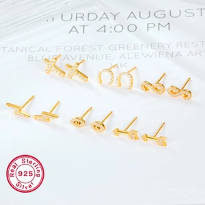 925 silver stud earrings set in gold with cross lightning and evil eye symbols