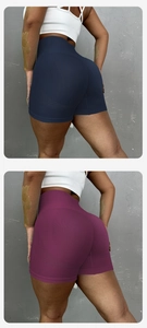 Close-up of seamless scrunch butt yoga shorts in navy and plum with wide waistband