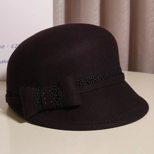 Close-up of elegant wool cloche hat with black lace trim and bow knot detail