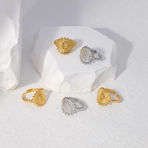 Close-up of adjustable titanium steel letter rings in gold and silver on white stone