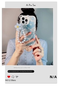 Detail of blue floral iPhone case featuring a stylish beaded wrist strap and flower charm