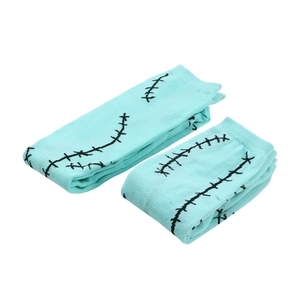 Detail of mint green knit socks with black stitch patterns for Halloween costumes