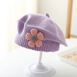 Cute purple knit beret for baby girls featuring a pink flower detail and ribbed brim