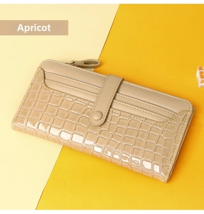 Detail view of apricot faux crocodile long wallet with multi-card slots and secure zipper