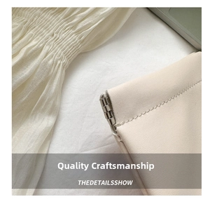 Detail of beige pleated fabric texture with premium light apricot leather and silver metal hinge