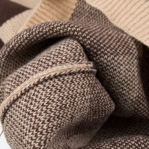 Macro shot of brown and beige checkered knit fabric texture and soft material details