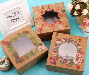 Detail of Christmas kraft paper muffin boxes with festive prints and clear PVC windows