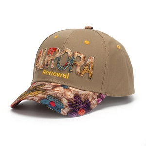 Detail of floral embroidery and Aurora letter patch on khaki cotton baseball cap