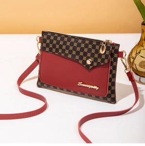 Detail view of the vintage monogram shoulder bag with red trim and gold logo