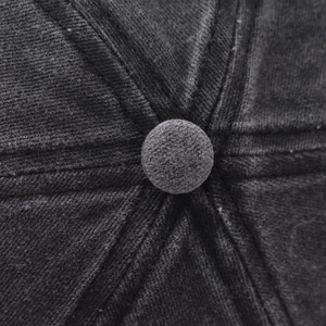 Close-up of high-quality corduroy baseball cap crown with detailed stitching and top button