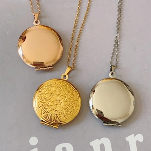 Set of round stainless steel locket necklaces in gold, silver, and rose gold with floral relief