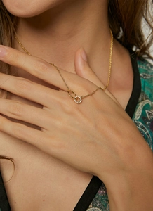 Detail of interlocking circles necklace with gold plating and sparkling zircon pavé stones