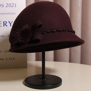 Elegant wine red wool cloche hat featuring a bow accent and plush mink fur ball detail
