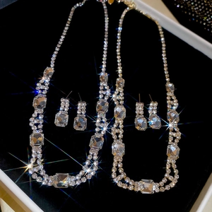 Macro view of luxury square diamond jewelry set in black velvet gift box with starburst