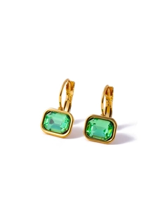 Close-up of gold huggie earrings with rectangular green zircon pendants on white background
