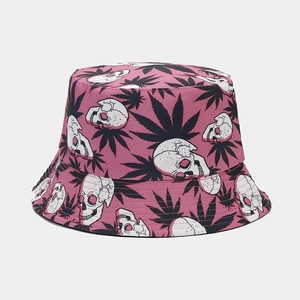 Detail of reversible bucket hat with pink skull and leaf pattern on breathable cotton fabric