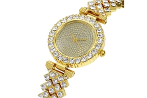 Macro shot of gold quartz watch with rhinestones on bezel and dial for women