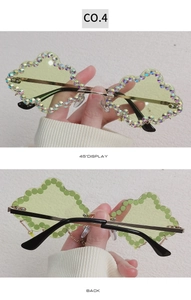 Detail of cloud-shaped sunglasses with light green lenses and sparkling rhinestones