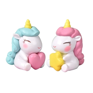 Cute cartoon unicorn cake toppers with heart and star decorations on white background
