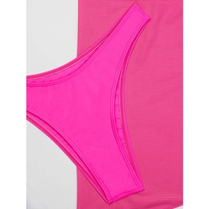 Detail shot of bright pink high-cut bikini bottoms with elastic ribbed texture fabric