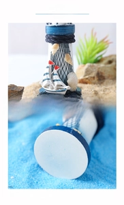 Detail of wooden lighthouse decor with real shells, hemp rope and fishing net texture