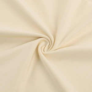 Macro shot of beige ruched fabric showing fine knitted texture and elastic draping details