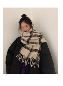 Detail view of winter plaid scarf in beige and khaki with soft decorative fringe