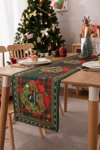 Detail of Christmas table runner featuring festive wreath and Merry Christmas text