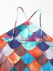 Detailed macro view of mermaid scale print fabric with golden lines and adjustable straps