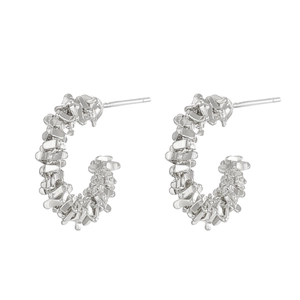 Close-up of silver C-shaped hoop earrings with irregular textured crushed silver finish