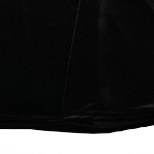 Close-up of black velvet evening dress fabric showing soft texture and hemline stitching