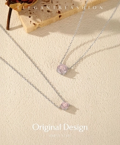 Detail of S925 silver necklace featuring a rose cut pink gemstone on stone texture