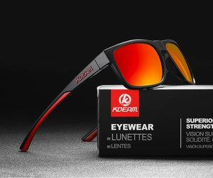 Close-up of black matte polarized sunglasses with orange-red lenses on branded box