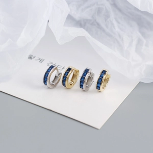 Detail of S925 silver hoop earrings set with blue square-cut cubic zirconia stones