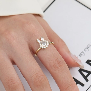 Detail of a rotating rabbit ring with white zircons and gold-plated finish for women