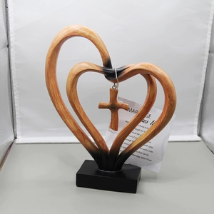 Detail of resin double heart desktop sculpture with hanging cross and scripture tag