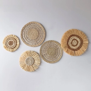 Set of 5 woven wall baskets with raffia edges and spiral patterns for boho home decor